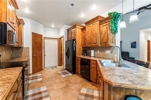 903 Howenstein St, Cameron, MO 64429 - kitchen with black appliances, light countertops, decorative backsplash, brown cabinets, and recessed lighting
