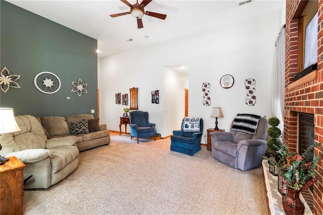 903 Howenstein St, Cameron, MO 64429 - carpeted living room featuring ceiling fan, a brick fireplace, and a towering ceiling