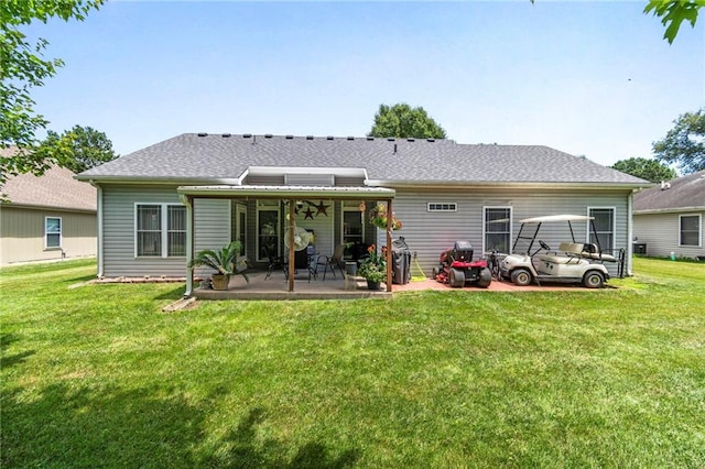903 Howenstein St, Cameron, MO 64429 - rear view of house with a patio area, a lawn, and roof with shingles