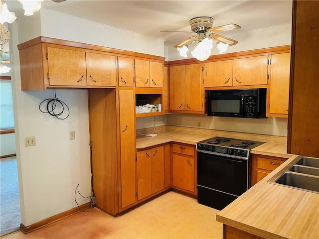 506 1st Ter, Lansing, KS 66043 - kitchen with range with electric cooktop, black microwave, light countertops, light flooring, and ceiling fan
