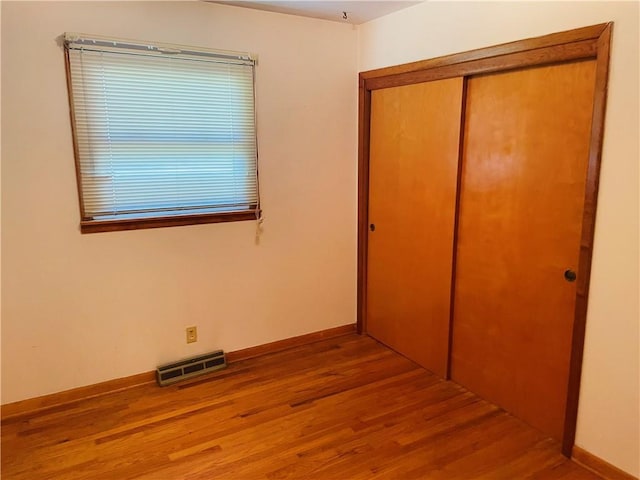 506 1st Ter, Lansing, KS 66043 - unfurnished bedroom with wood finished floors and a closet