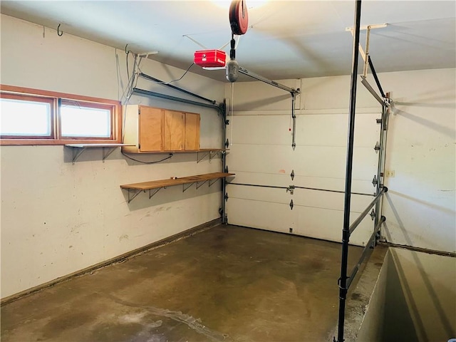 506 1st Ter, Lansing, KS 66043 - garage featuring a garage door opener and baseboards