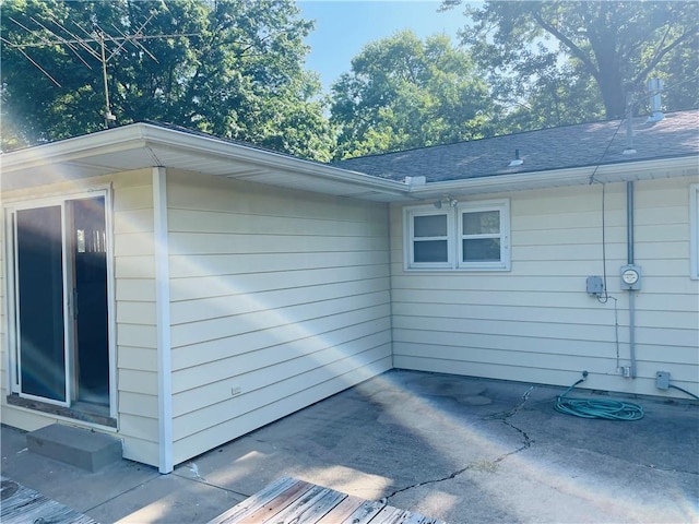 506 1st Ter, Lansing, KS 66043 - view of side of home with a patio area and a shingled roof