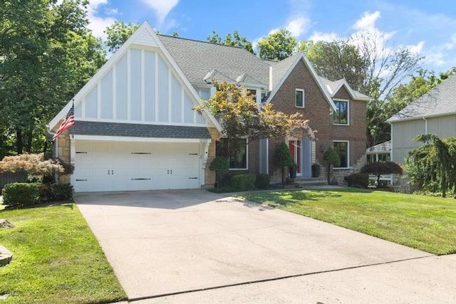 12312 Nieman Rd, Overland Park, KS 66213 - tudor house featuring driveway, a front yard, an attached garage, and brick siding