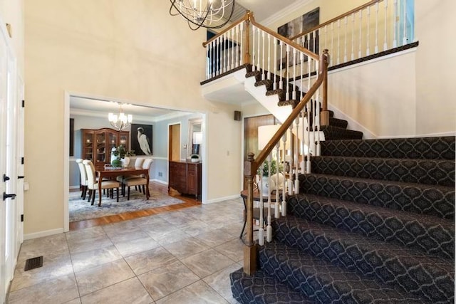 12312 Nieman Rd, Overland Park, KS 66213 - foyer with a chandelier, stairs, a high ceiling, and ornamental molding