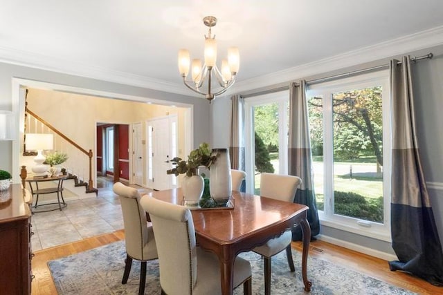 12312 Nieman Rd, Overland Park, KS 66213 - dining area featuring a chandelier, healthy amount of natural light, ornamental molding, stairway, and light wood-style floors