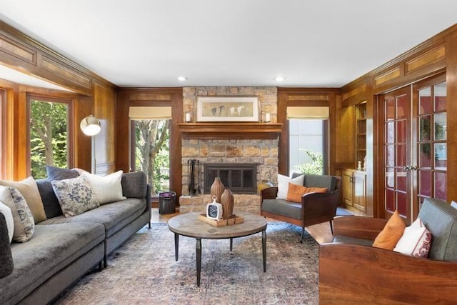 12312 Nieman Rd, Overland Park, KS 66213 - living area with a fireplace, built in features, wood walls, recessed lighting, and french doors