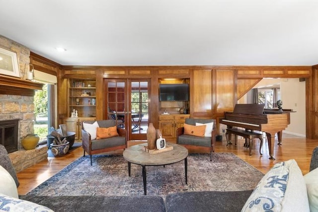 12312 Nieman Rd, Overland Park, KS 66213 - living area with built in shelves, french doors, a fireplace, and wood finished floors