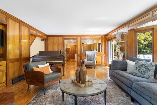 12312 Nieman Rd, Overland Park, KS 66213 - living room featuring light wood-style floors, wooden walls, and ornamental molding