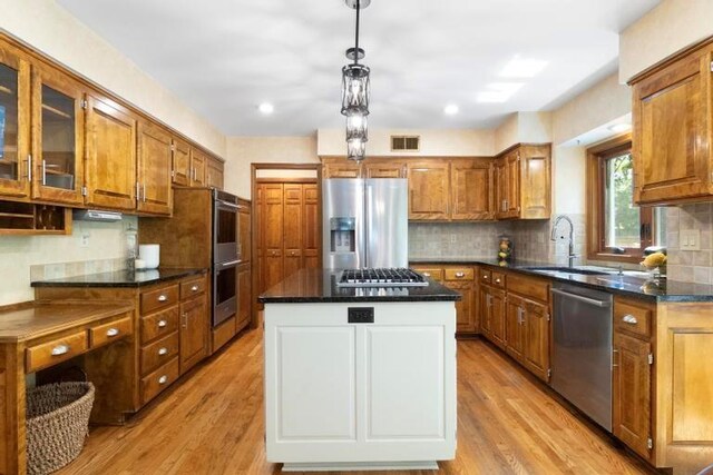 12312 Nieman Rd, Overland Park, KS 66213 - kitchen featuring stainless steel appliances, brown cabinets, light wood-type flooring, and recessed lighting