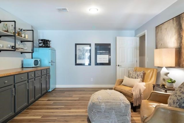 12312 Nieman Rd, Overland Park, KS 66213 - sitting room with wood finished floors and baseboards