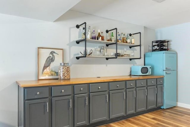 12312 Nieman Rd, Overland Park, KS 66213 - indoor bar featuring light wood-style floors and freestanding refrigerator