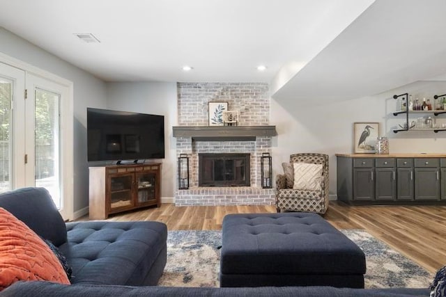 12312 Nieman Rd, Overland Park, KS 66213 - living room with wood finished floors, a fireplace, recessed lighting, and bar area