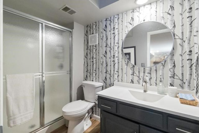 12312 Nieman Rd, Overland Park, KS 66213 - bathroom with vanity, a shower stall, and wood finished floors