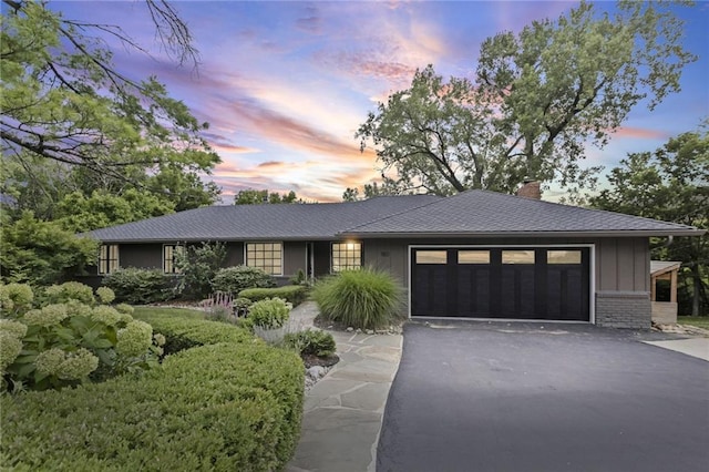 180 Terrace Trl S, Lake Quivira, KS 66217 - ranch-style home featuring asphalt driveway, a chimney, an attached garage, and board and batten siding