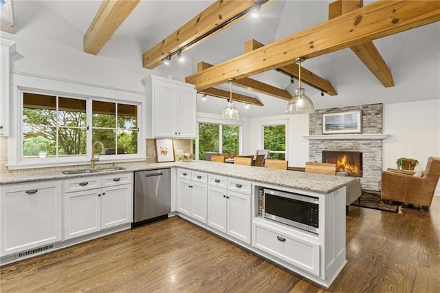 180 Terrace Trl S, Lake Quivira, KS 66217 - kitchen with stainless steel appliances, a peninsula, tasteful backsplash, beam ceiling, and track lighting