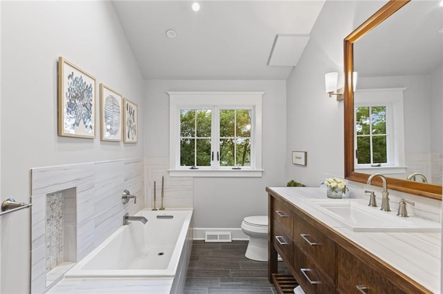 180 Terrace Trl S, Lake Quivira, KS 66217 - full bathroom featuring healthy amount of natural light, vanity, a garden tub, wood finished floors, and lofted ceiling
