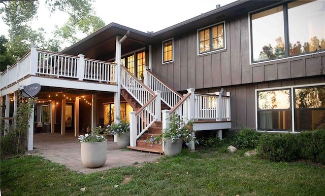 180 Terrace Trl S, Lake Quivira, KS 66217 - back of house with board and batten siding, a patio area, a yard, and a deck