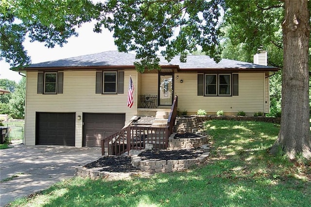 407 Hithergreen Dr, Lansing, KS 66043 - ranch-style home with a garage, a chimney, driveway, and a front yard