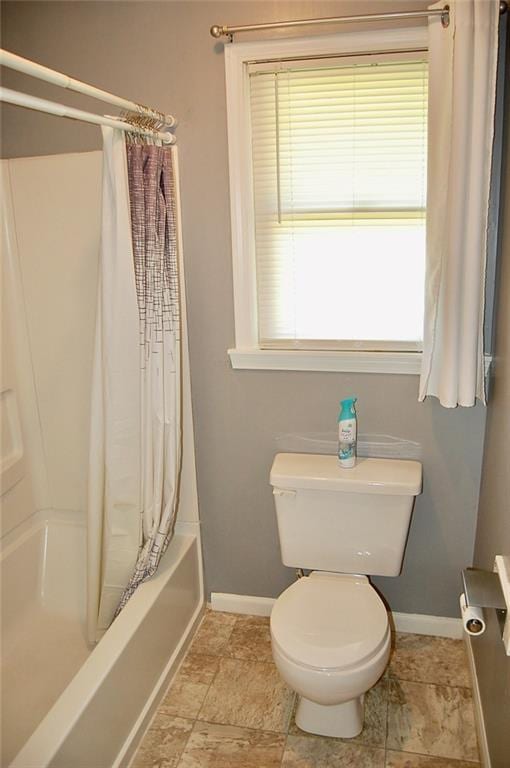 407 Hithergreen Dr, Lansing, KS 66043 - bathroom with baseboards and shower / bath combo with shower curtain