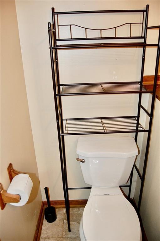 407 Hithergreen Dr, Lansing, KS 66043 - bathroom featuring toilet and baseboards