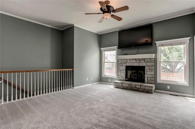 1039 Woodson Cir, Gardner, KS 66030 - unfurnished living room featuring a ceiling fan, carpet floors, ornamental molding, a stone fireplace, and a textured ceiling