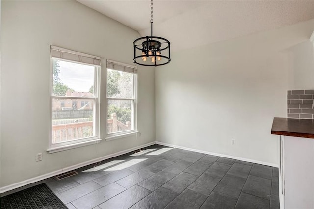 1039 Woodson Cir, Gardner, KS 66030 - unfurnished dining area featuring a chandelier and baseboards