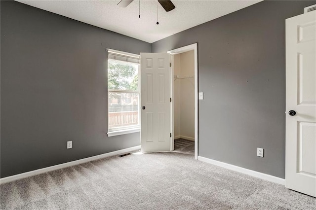 1039 Woodson Cir, Gardner, KS 66030 - carpeted spare room with ceiling fan and a textured ceiling