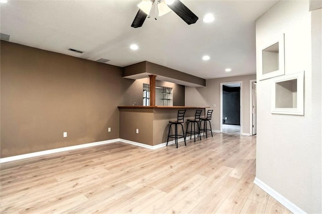 1039 Woodson Cir, Gardner, KS 66030 - empty room with bar, light wood-style flooring, a ceiling fan, and recessed lighting
