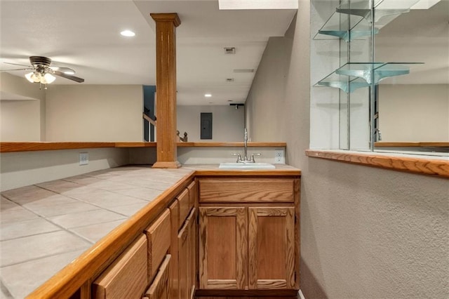 1039 Woodson Cir, Gardner, KS 66030 - bathroom with vanity, ornate columns, a ceiling fan, a textured wall, and recessed lighting