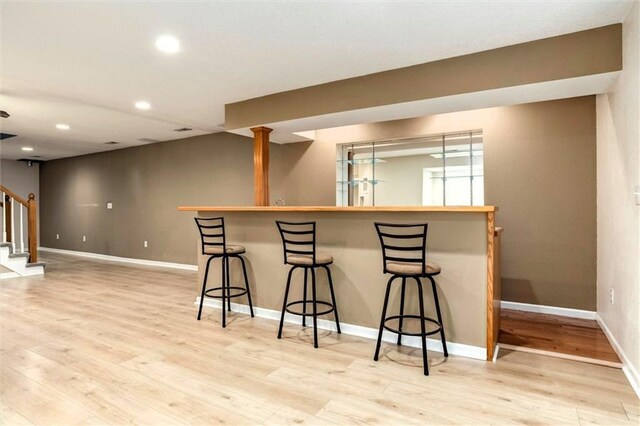 1039 Woodson Cir, Gardner, KS 66030 - indoor bar with stairway, wood finished floors, and recessed lighting