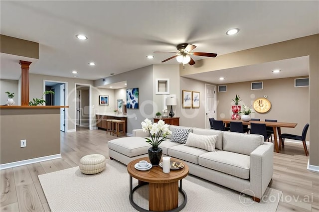1039 Woodson Cir, Gardner, KS 66030 - living area with recessed lighting, ceiling fan, light wood finished floors, and ornate columns