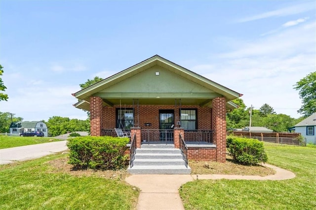 1340 Spruce St, Leavenworth, KS 66048 - bungalow-style house with a porch and brick siding