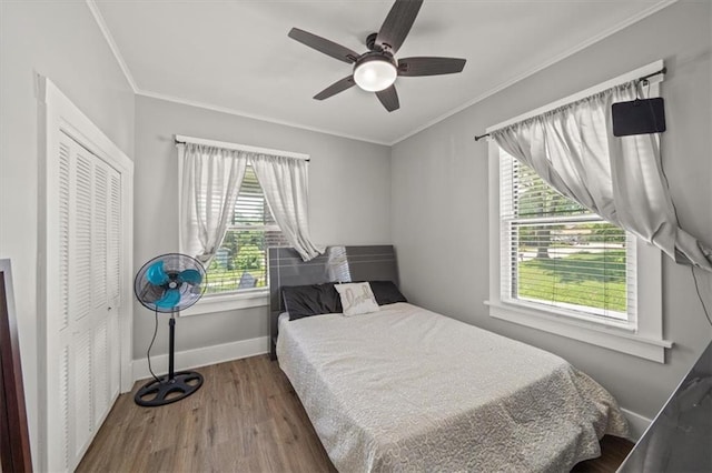 1340 Spruce St, Leavenworth, KS 66048 - bedroom with wood finished floors, ornamental molding, a ceiling fan, and a closet