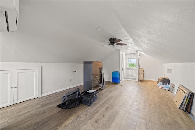 1340 Spruce St, Leavenworth, KS 66048 - bonus room featuring wood finished floors, a ceiling fan, lofted ceiling, and a textured ceiling