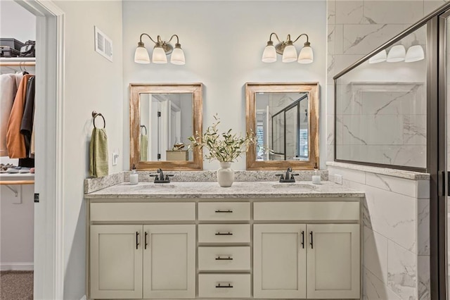 801 155th Ter, Basehor, KS 66007 - bathroom featuring double vanity, a marble finish shower, and a spacious closet