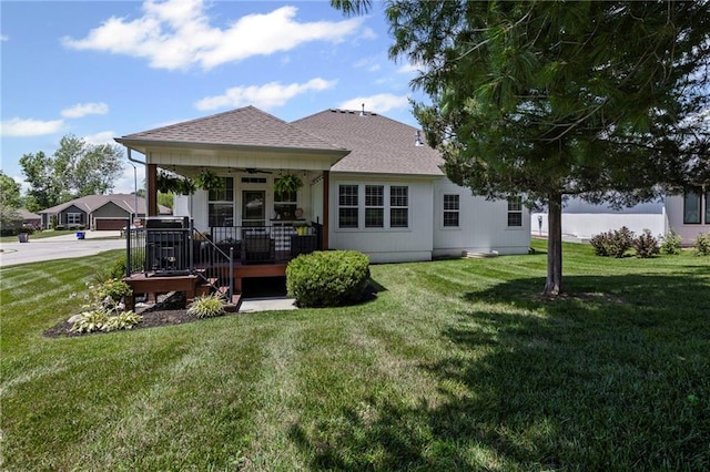 801 155th Ter, Basehor, KS 66007 - back of property featuring a ceiling fan, a lawn, and roof with shingles
