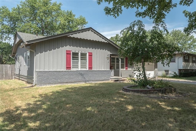 1222 S Maple St, Ottawa, KS 66067 - view of front of house featuring an attached garage and board and batten siding