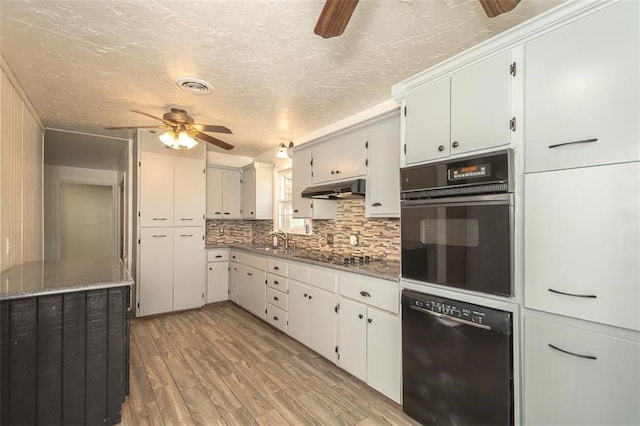 1222 S Maple St, Ottawa, KS 66067 - kitchen featuring black appliances, ceiling fan, under cabinet range hood, tasteful backsplash, and light wood-style floors