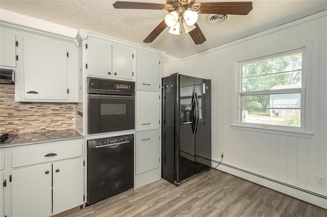 1222 S Maple St, Ottawa, KS 66067 - kitchen featuring black appliances, a baseboard radiator, backsplash, light wood finished floors, and white cabinetry