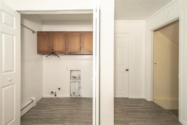 1222 S Maple St, Ottawa, KS 66067 - laundry area with a baseboard heating unit, cabinet space, electric dryer hookup, dark wood-type flooring, and ornamental molding