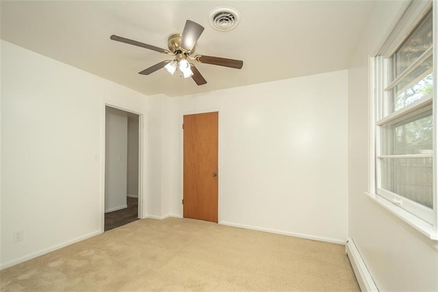 1222 S Maple St, Ottawa, KS 66067 - unfurnished room featuring light carpet, baseboard heating, and a ceiling fan