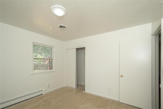 1222 S Maple St, Ottawa, KS 66067 - unfurnished bedroom featuring a baseboard radiator, light colored carpet, and a closet