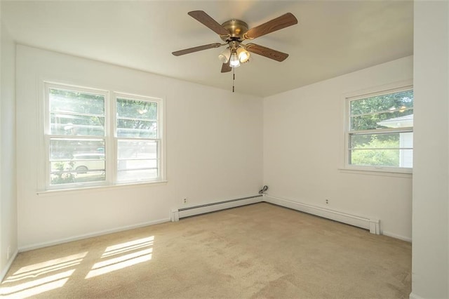 1222 S Maple St, Ottawa, KS 66067 - spare room featuring light colored carpet, a baseboard radiator, and a ceiling fan