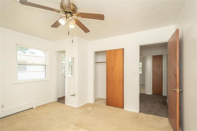 1222 S Maple St, Ottawa, KS 66067 - unfurnished bedroom with baseboard heating, light carpet, a closet, and ceiling fan