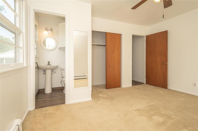 1222 S Maple St, Ottawa, KS 66067 - unfurnished bedroom with carpet flooring, baseboard heating, multiple windows, and a closet