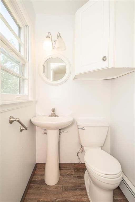 1222 S Maple St, Ottawa, KS 66067 - half bathroom with baseboard heating and wood finished floors