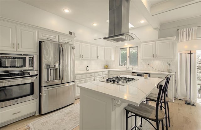 12600 Mohawk Ln, Leawood, KS 66209 - kitchen with stainless steel appliances, island range hood, white cabinetry, tasteful backsplash, and light stone counters
