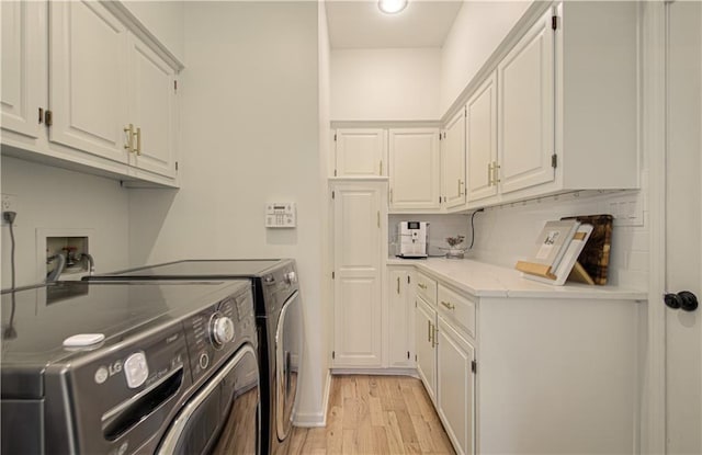12600 Mohawk Ln, Leawood, KS 66209 - washroom featuring washer and clothes dryer, cabinet space, and light wood-type flooring