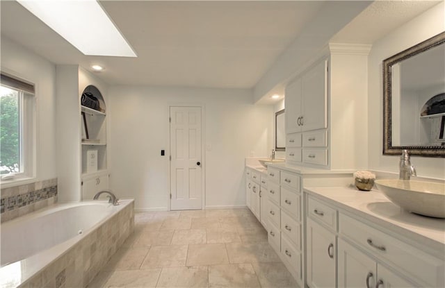 12600 Mohawk Ln, Leawood, KS 66209 - bathroom featuring double vanity, a garden tub, a skylight, and recessed lighting